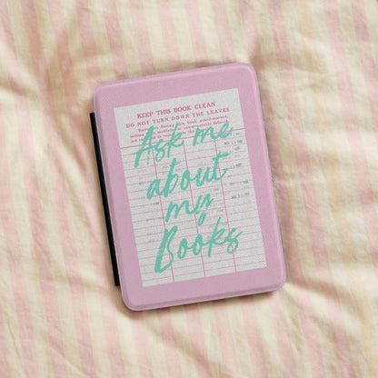 Ask Me About My Books Kindle case on a striped bedspread
