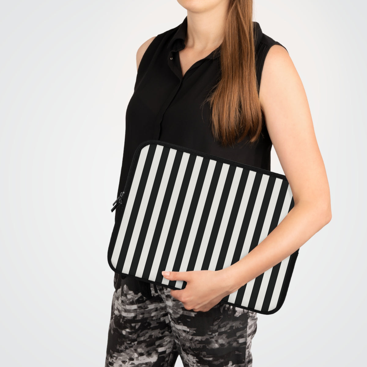 Woman carrying a Black Cabana Stripe laptop sleeve