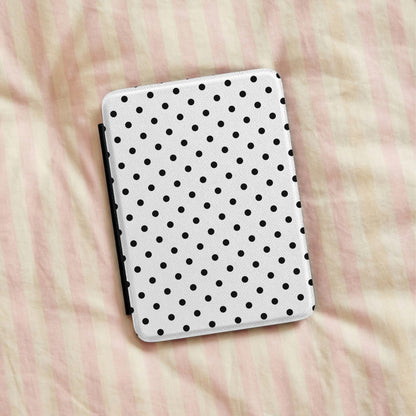 Black Polka Dot Kindle case lying on striped bedding