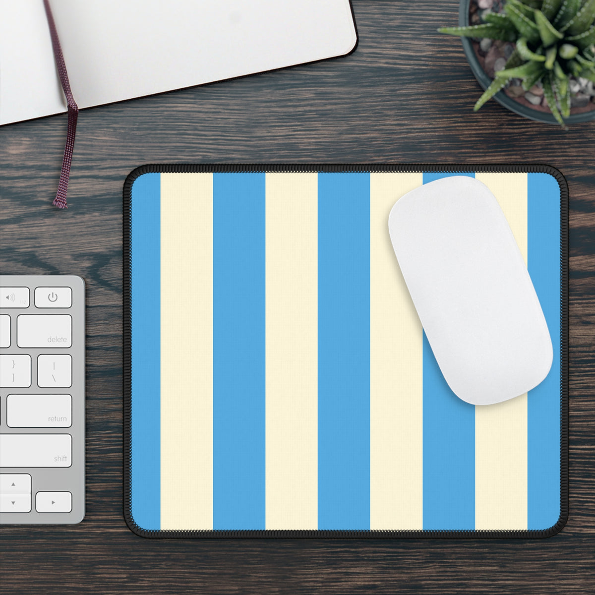 Blue cabana stripe mouse mat on a wooden desk beside a keyboard and mouse