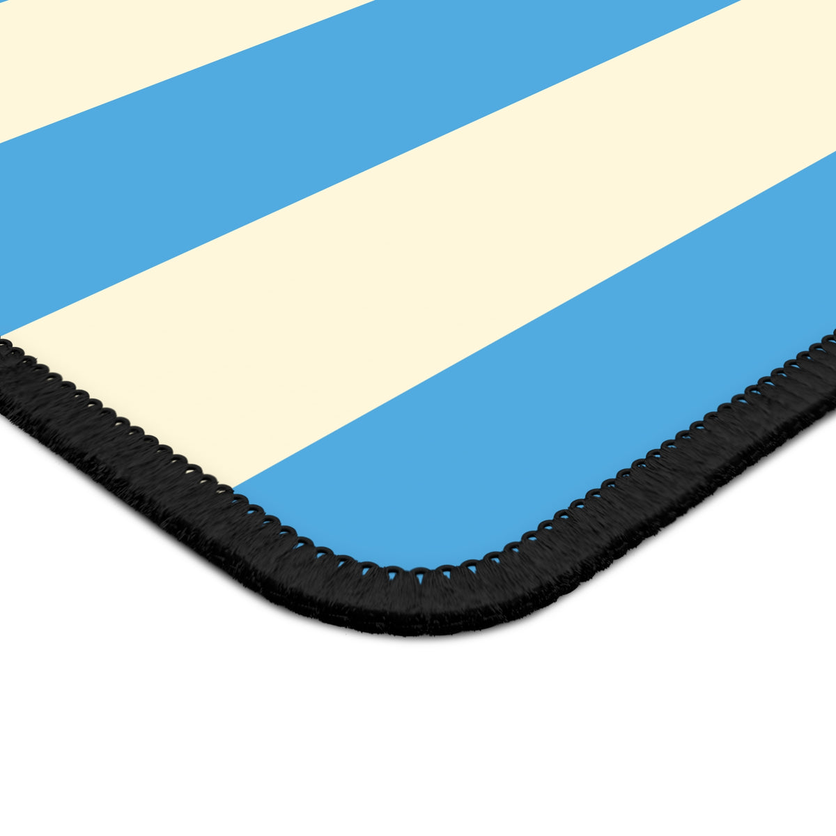 Close-up of the stitched edge of the blue cabana stripe mouse mat