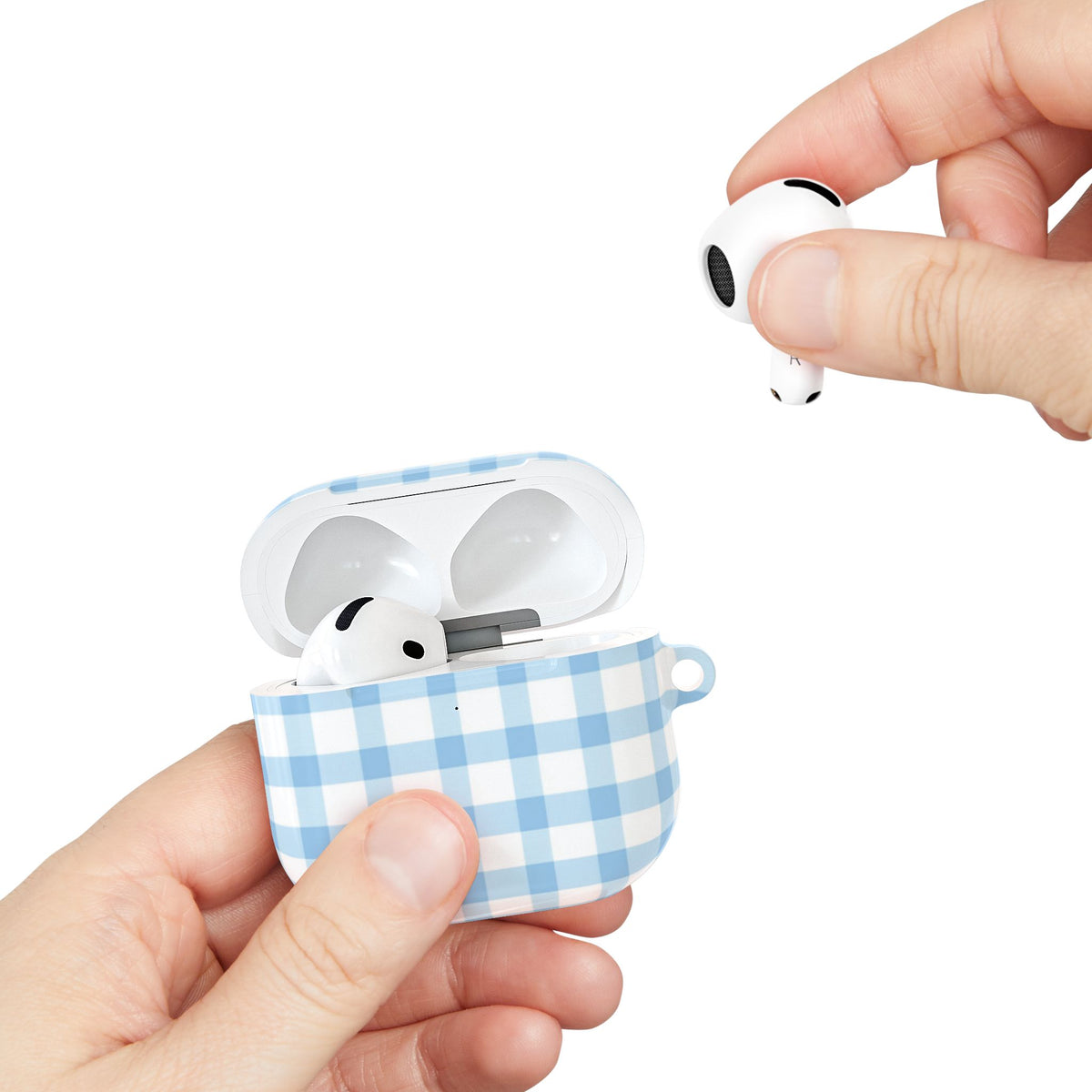 Blue gingham AirPods case held in hand while taking out an AirPod