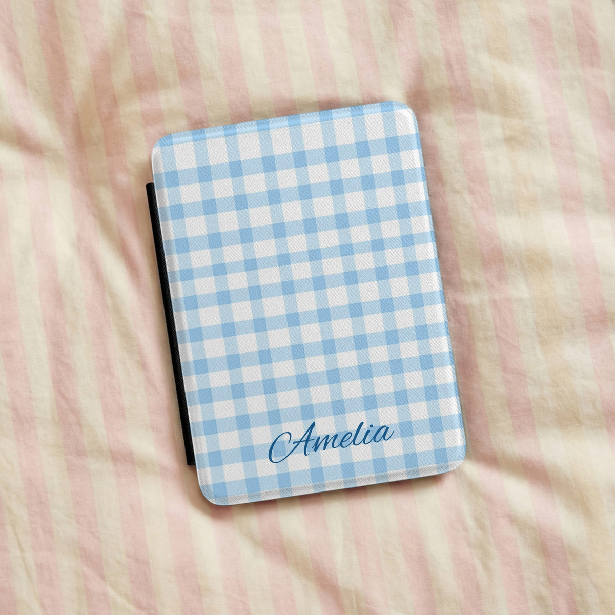 Blue gingham Kindle case on pink bed linen