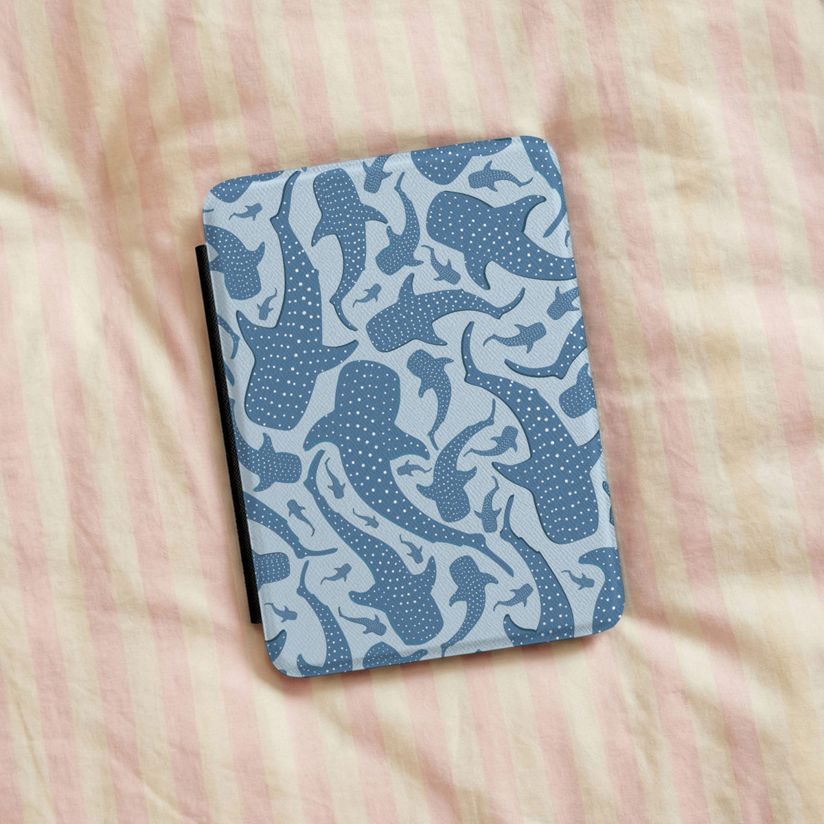 Blue whale shark Kindle case on striped bed linen