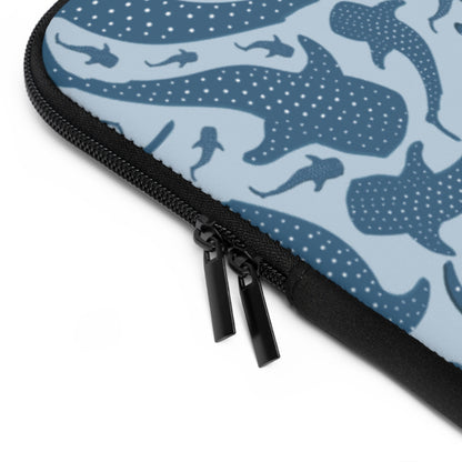 Blue Whale Shark laptop sleeve on a desk with a laptop sliding in