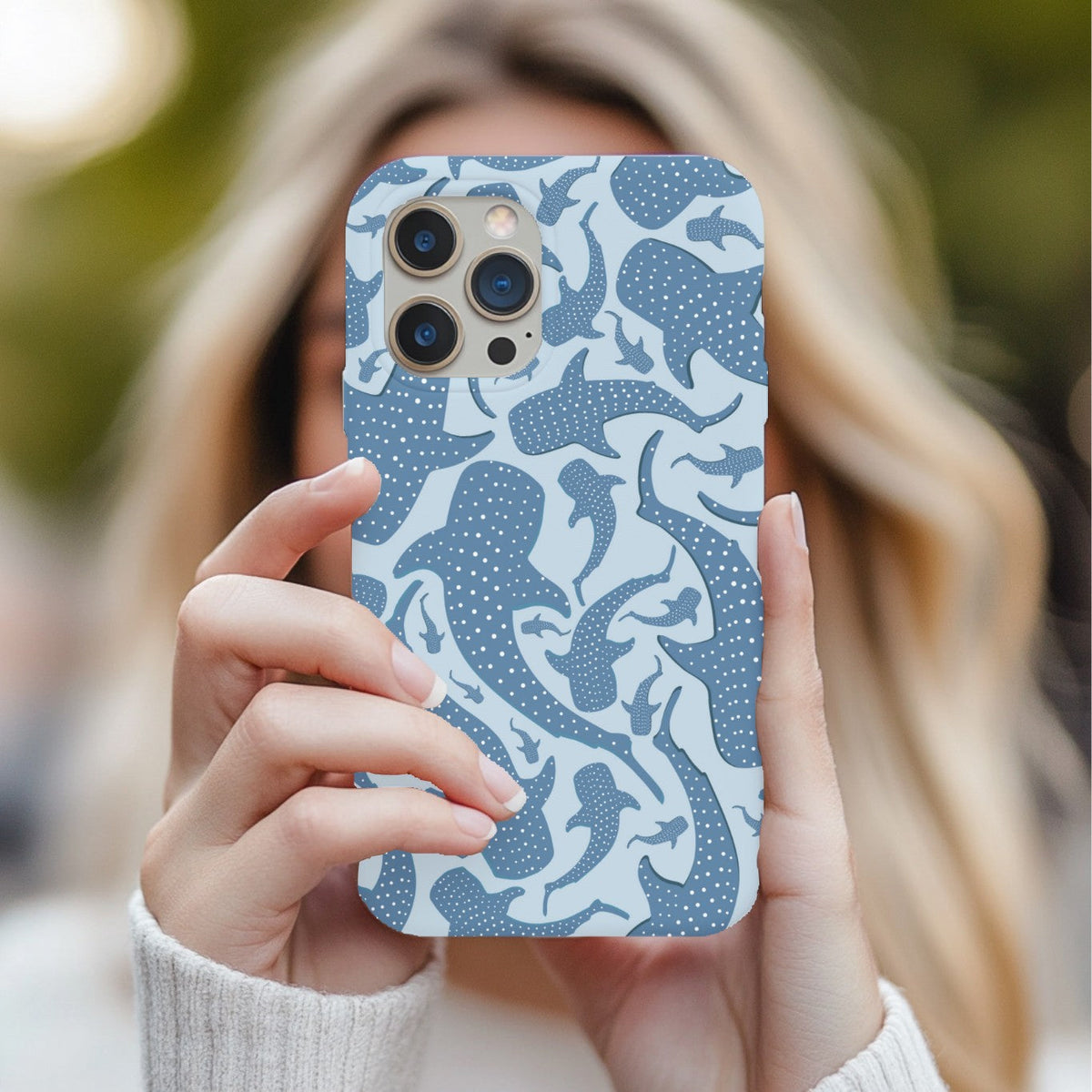 Woman holding a Blue Whale Shark phone case in front of her face