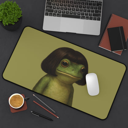 Bob Cut Frog desk mat on a dark desk with a laptop and mouse