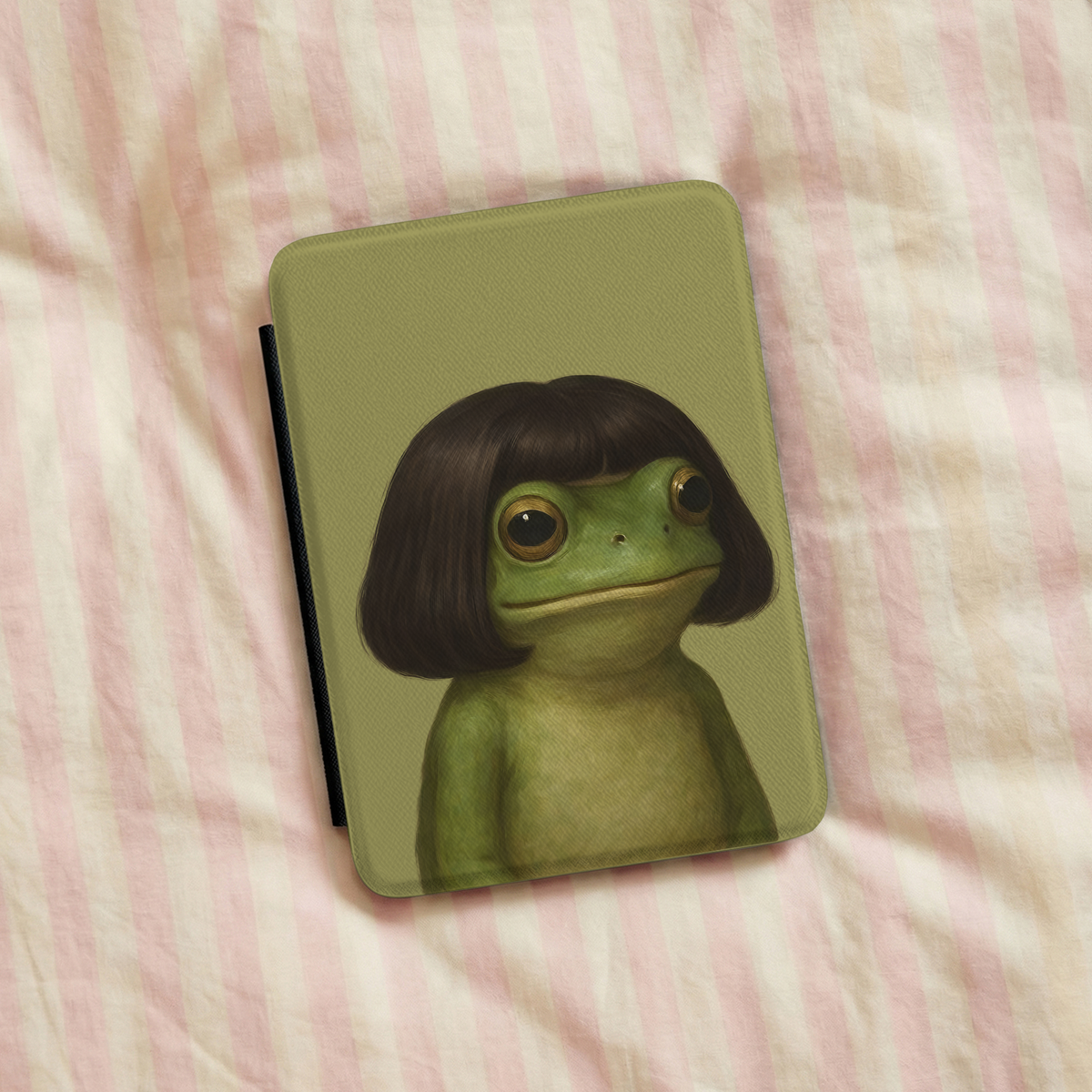 Bob Cut Frog Kindle case styled on a desk