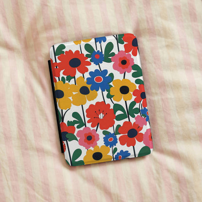 Bold Scandi Floral Kindle case lying on striped bedding