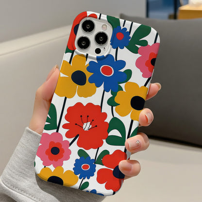 Bold Scandi Floral tough phone case held in one hand on a sofa