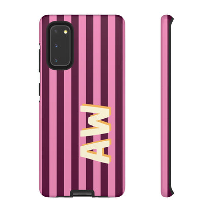 Vertical pink and plum striped phone case with monogram detail