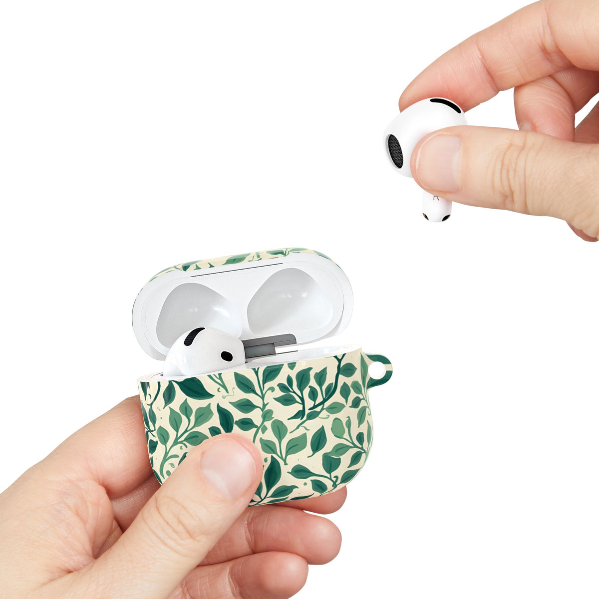 Botanical Leaf AirPods case held in hand while taking out an earbud