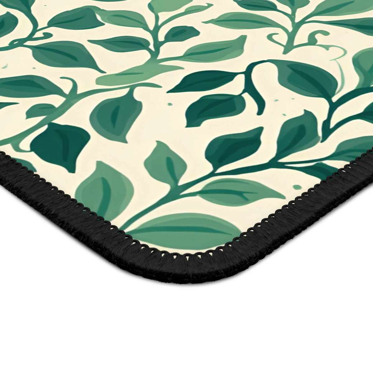 Close-up of the green leaves and stitched edge on the Botanical Leaf mouse mat