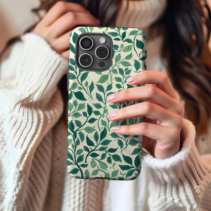 Woman in a cream sweater holding a Botanical Leaf tough phone case