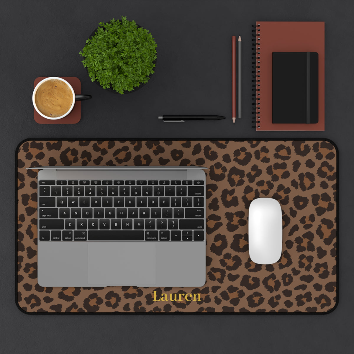 Brown leopard print desk mat on a dark desk with a laptop, mouse and coffee