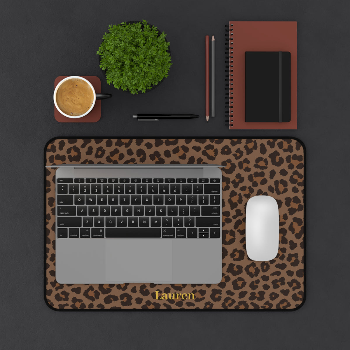 Brown leopard print desk mat in a smaller size with a laptop and plant