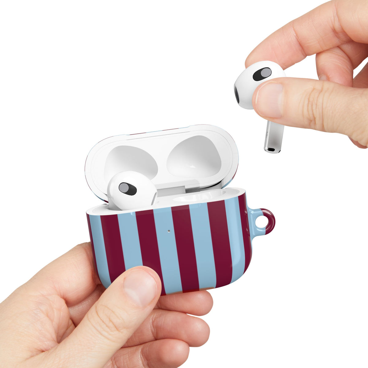 Burgundy Cabana Stripe AirPods case held in hand while taking out an AirPod