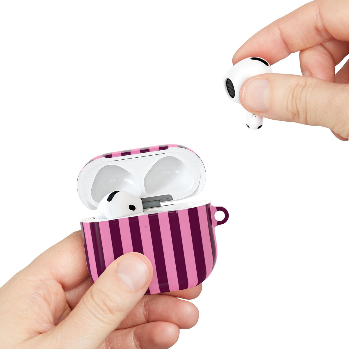 Burgundy Pink Cabana Stripe AirPods case held in hand while taking out an AirPod