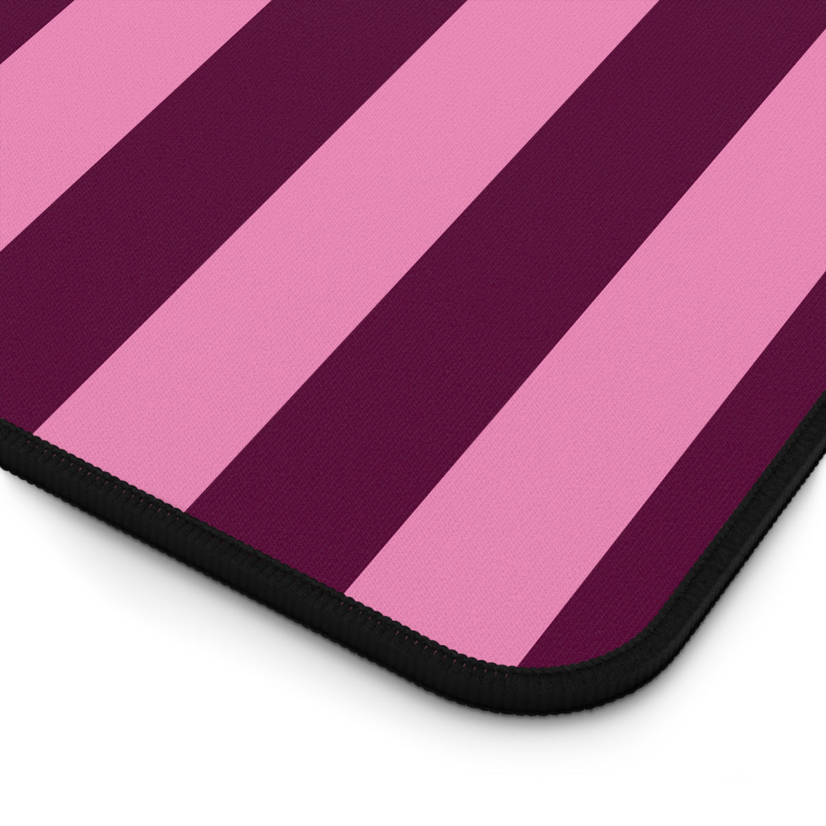 Close-up of the Burgundy Pink Cabana Stripe desk mat print and stitched edge