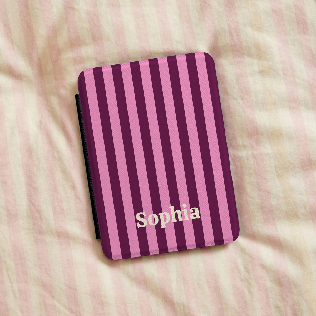 Burgundy Pink Cabana Stripe Kindle case on striped bed linen