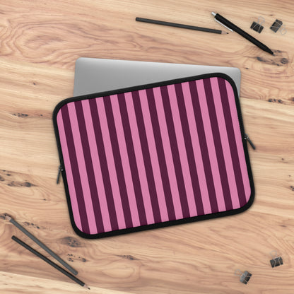 Burgundy Pink Cabana Stripe laptop sleeve on a wooden desk with a laptop