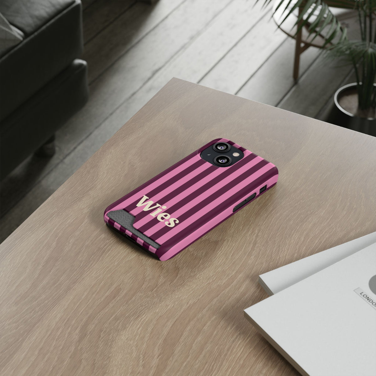 Burgundy Pink Cabana Stripe card holder phone case on a wooden desk