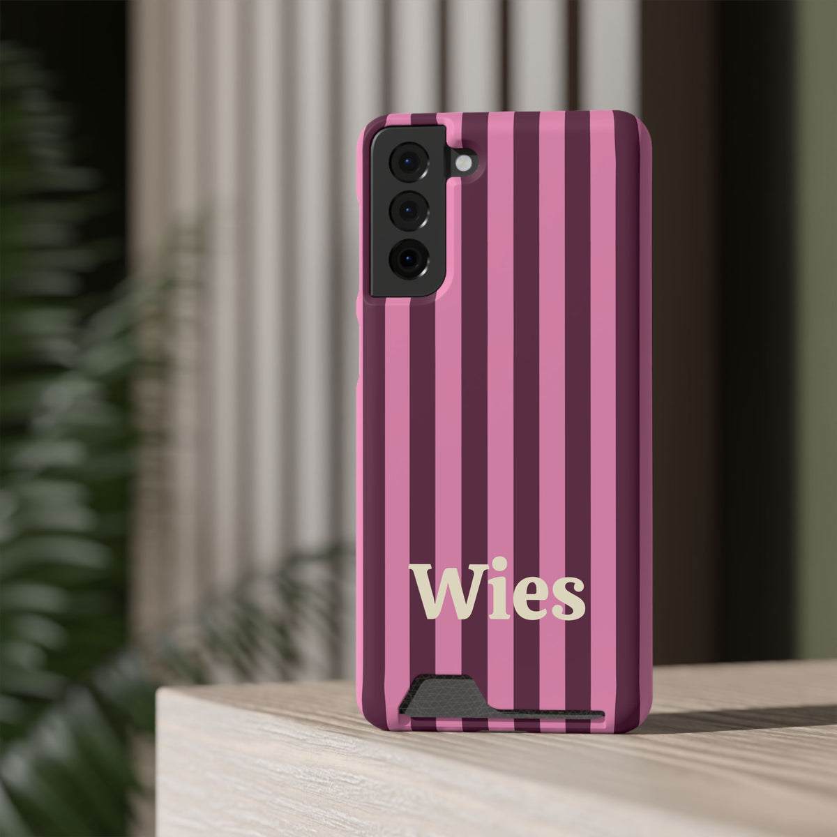 Burgundy Pink Cabana Stripe card holder phone case standing on a desk