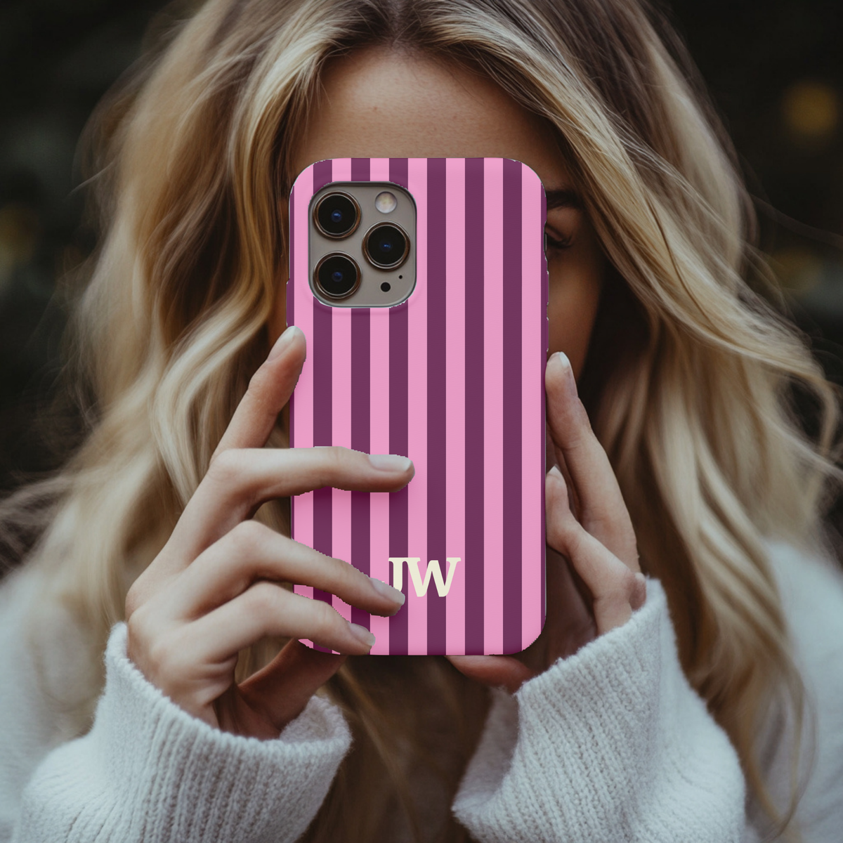 Woman holding a Burgundy Pink Cabana Stripe phone case with custom initials