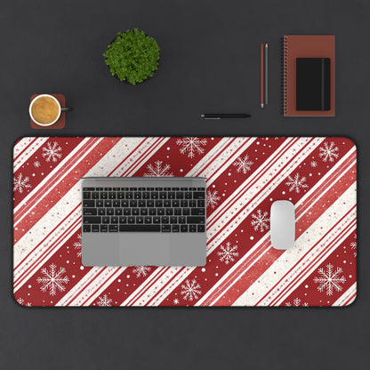 Candy Cane Snowflake desk mat with laptop and mouse on a dark desk