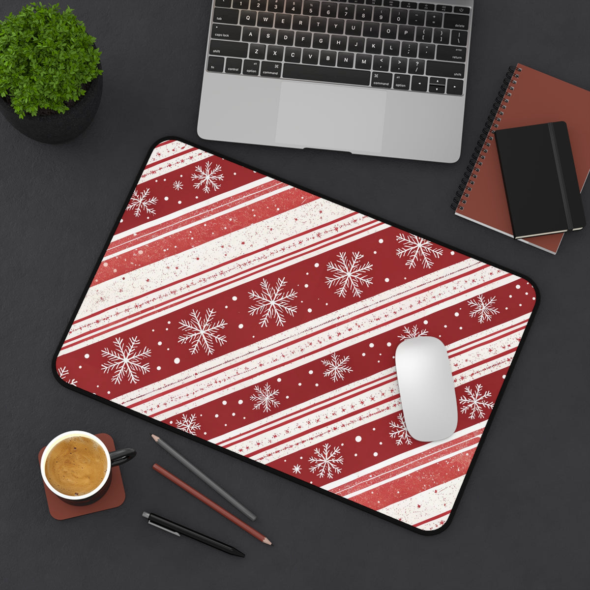 Candy Cane Snowflake desk mat angled on a desk with laptop