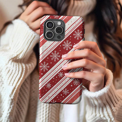 Candy Cane Snowflake tough phone case held against a cosy winter sweater