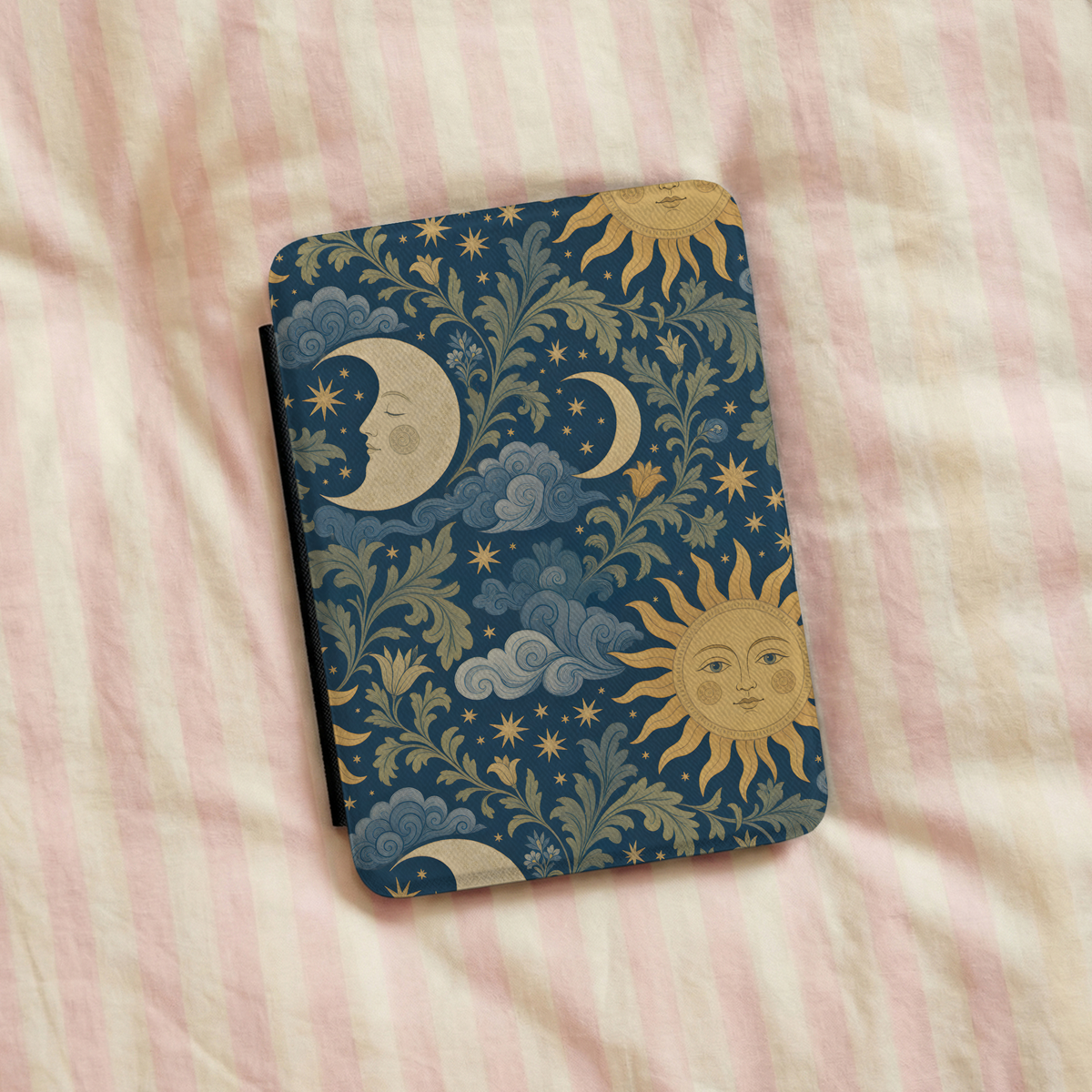 Celestial Garden Kindle case on striped bed linen