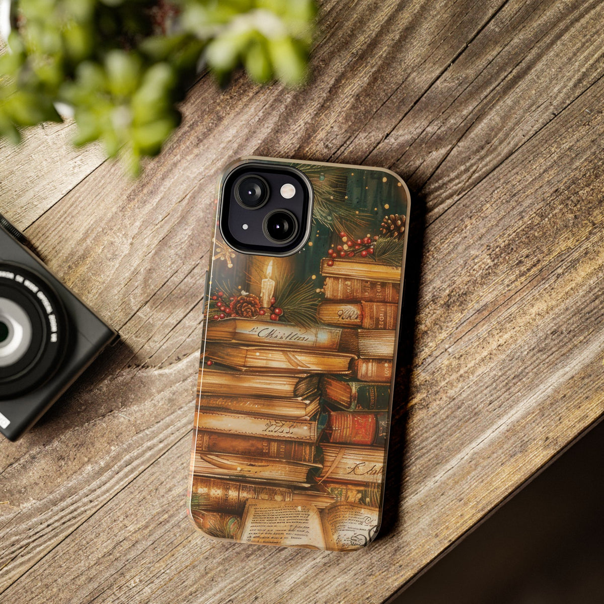 Christmas Books tough phone case on a desk next to a camera