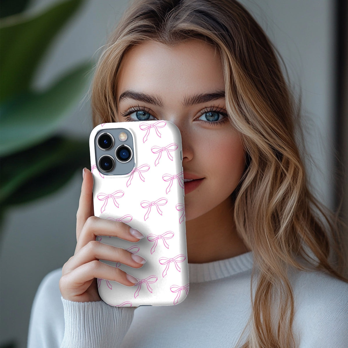 Coquette Bows phone case held up beside a face