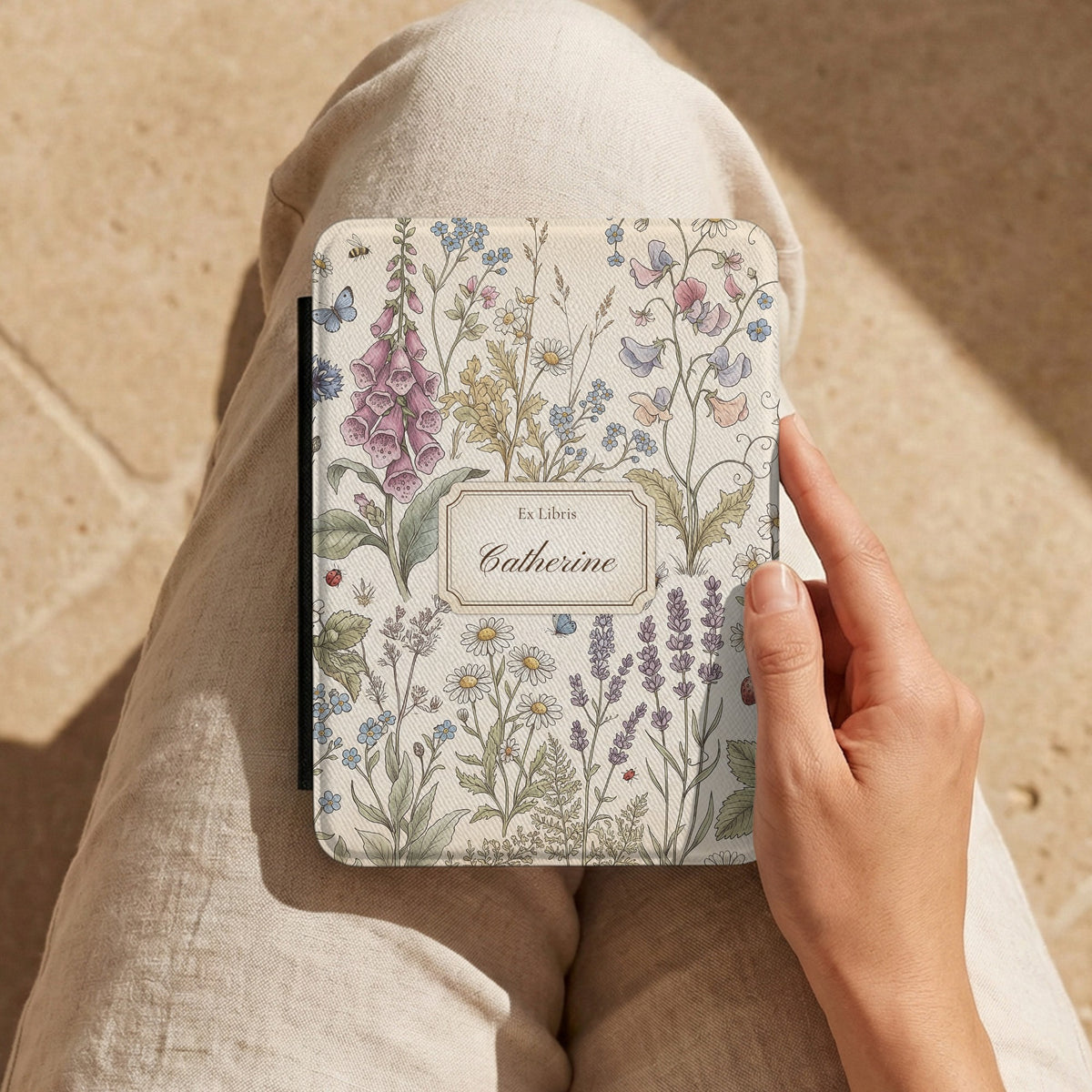 Cottage Meadow Ex Libris Kindle case held on the lap while reading