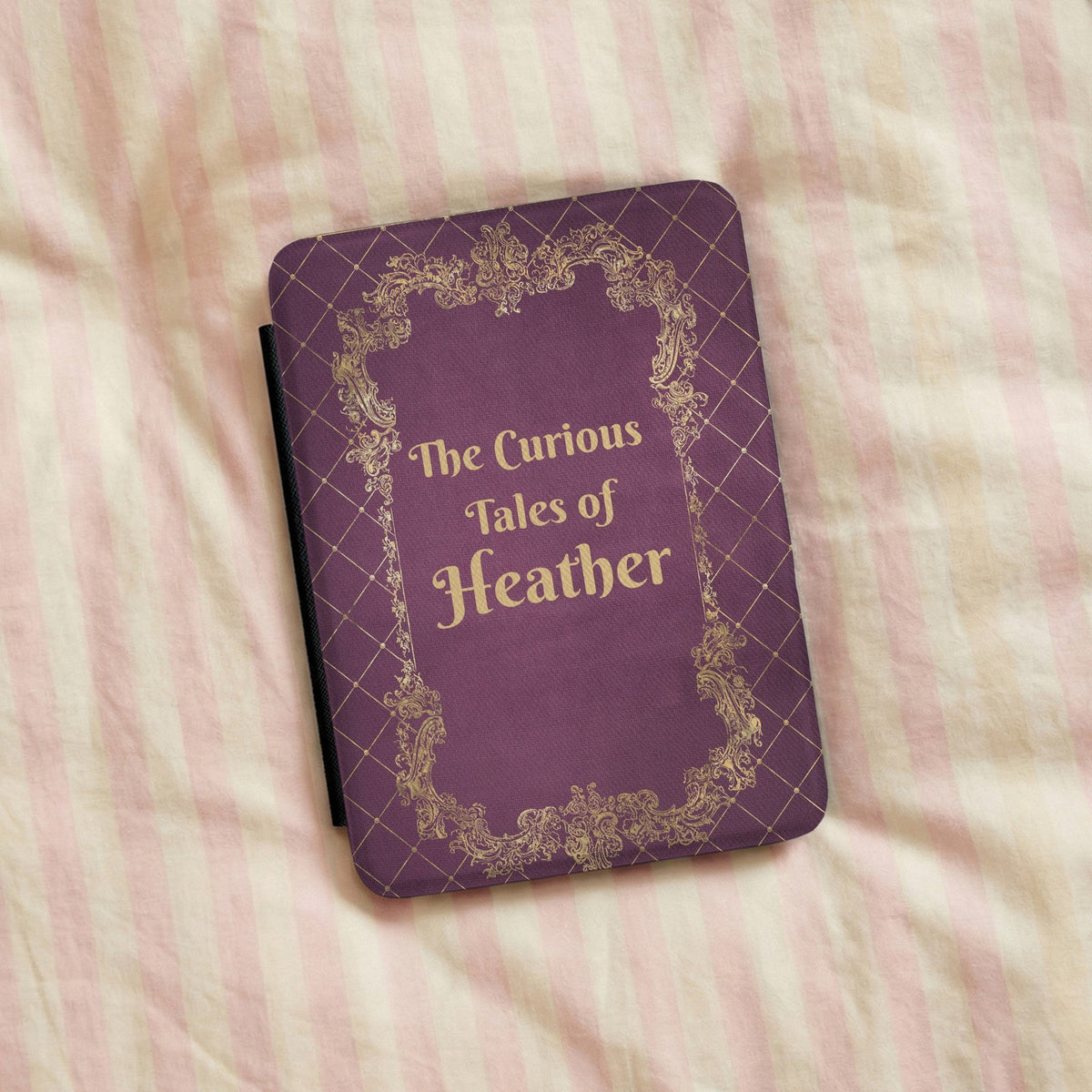 Personalised Curious Tales Kindle case on striped bed linen