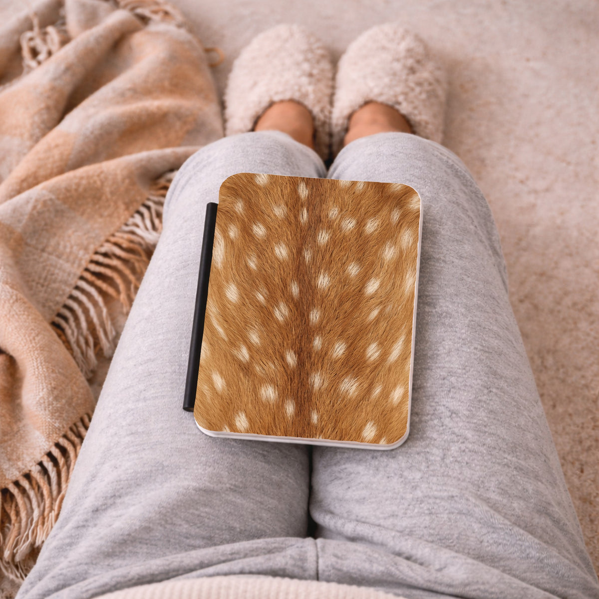Fawn Print Kindle case on a lap with a cosy blanket