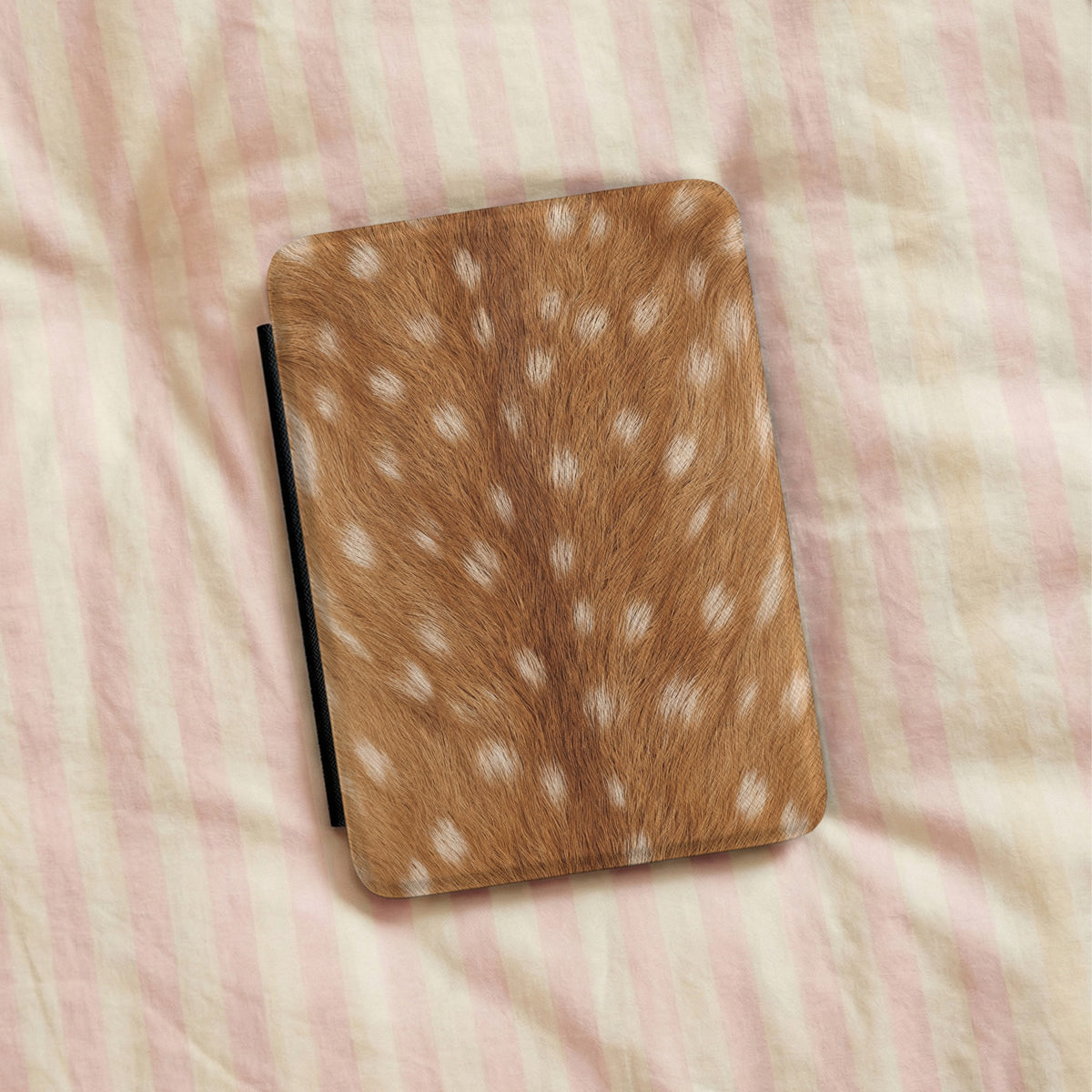 Fawn Print Kindle case lying on striped bedding