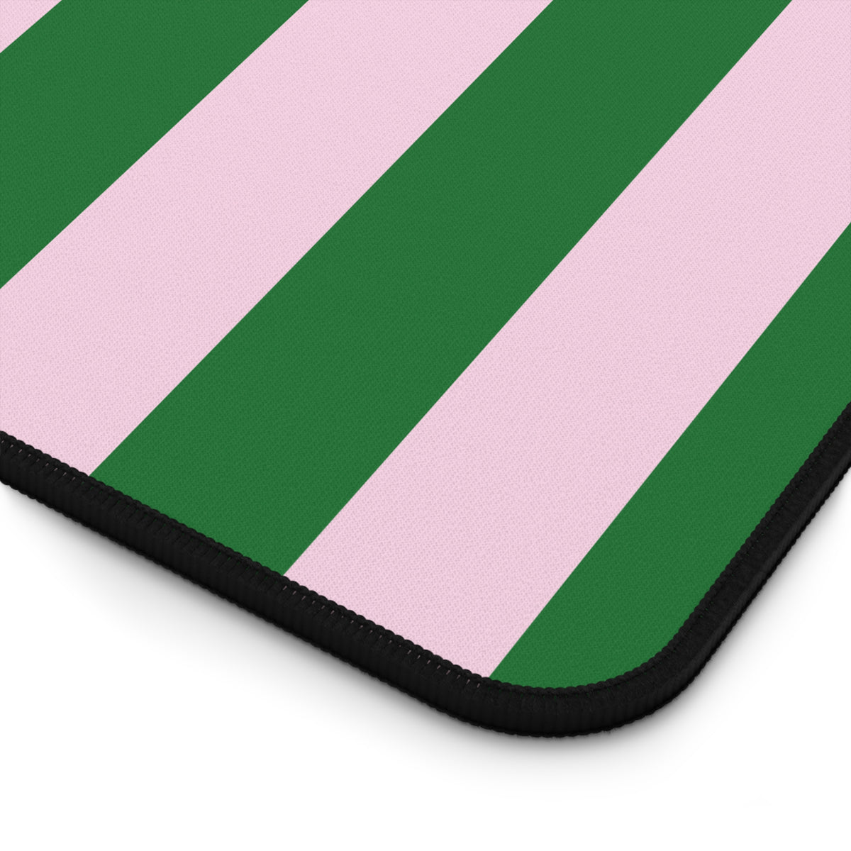 Close-up of the stitched edge and stripes of the green cabana stripe desk mat