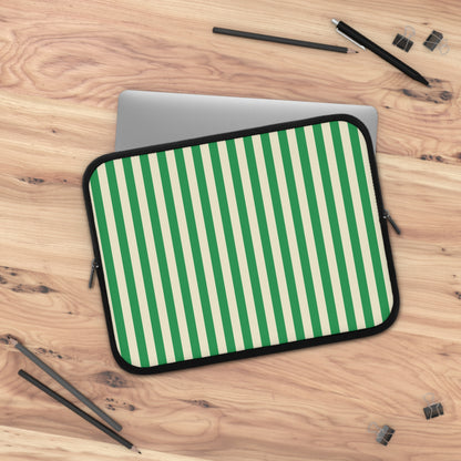 Green Cream Cabana Stripe laptop sleeve on a wooden desk with a laptop