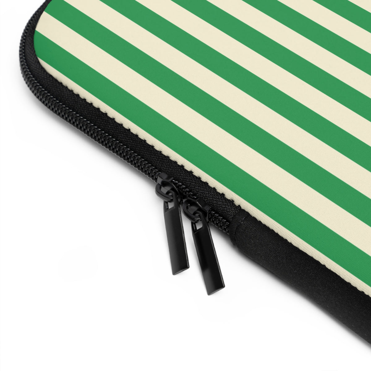 Close-up of the zipper and edge of the Green Cream Cabana Stripe laptop sleeve