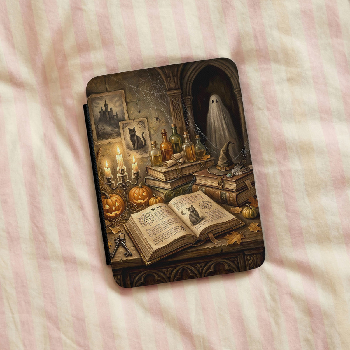 Haunted Library Kindle case on pink striped linen bedding