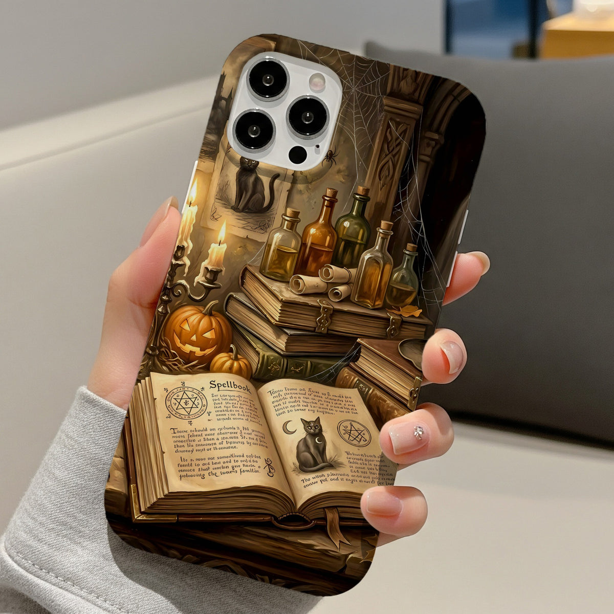 Haunted Library tough phone case held in one hand on a sofa