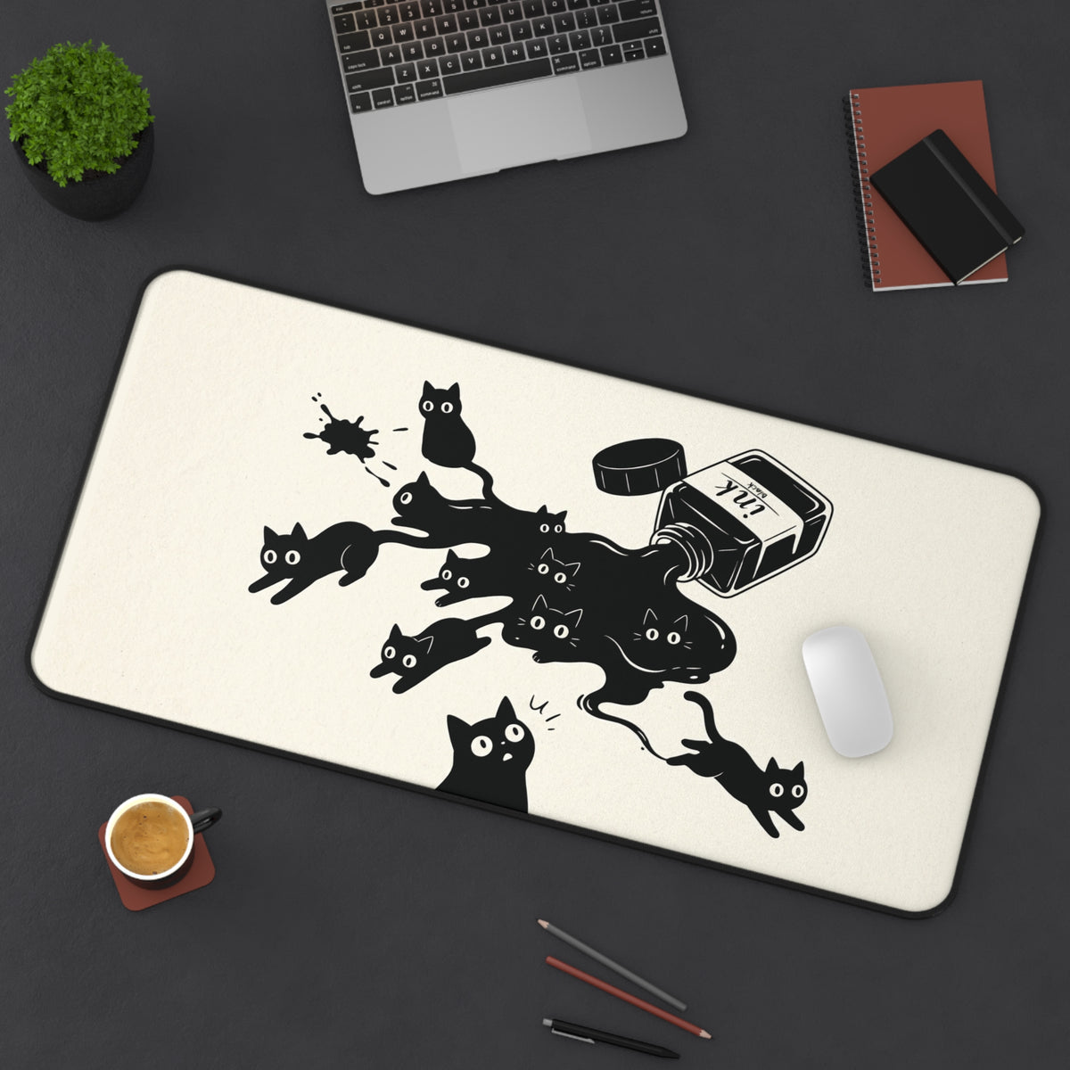 Ink Spill Cats desk mat in a wider size on a dark desk