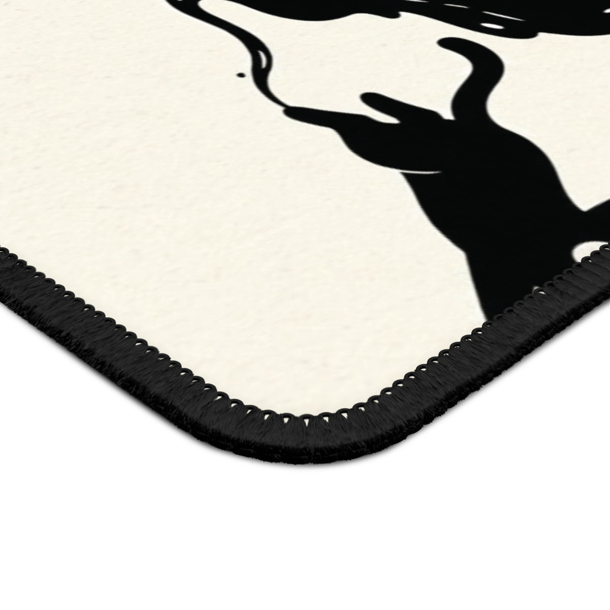 Close-up of the stitched edge of the Ink Spill Cats mouse mat