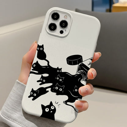 Ink Spill Cats tough phone case held in one hand at a desk