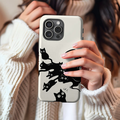 Ink Spill Cats tough phone case held in hand against a cream knit sweater