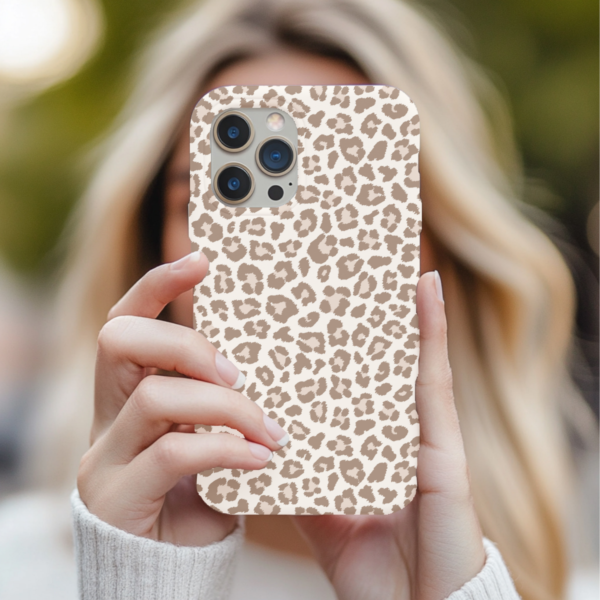Leopard print tough phone case held up to the face