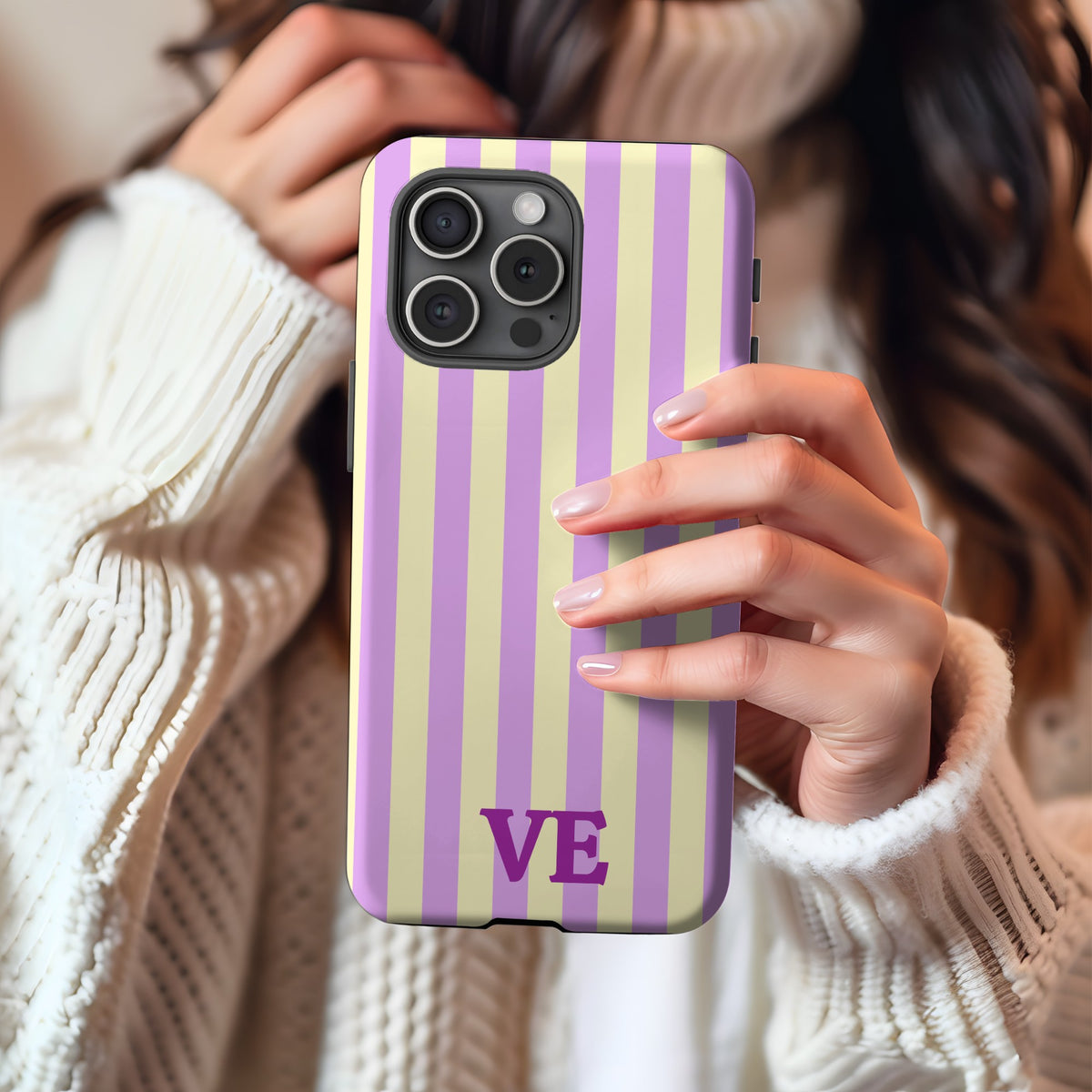 Woman in a cream sweater holding the Lilac Cabana Stripe tough phone case