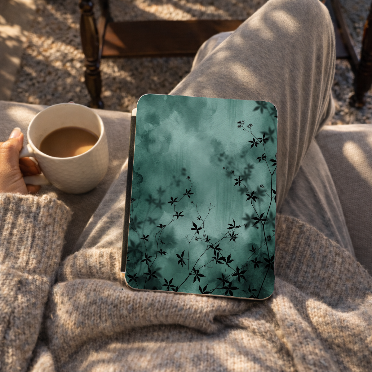 Midnight Garden Kindle case lifestyle photo with emerald watercolor plant shadows